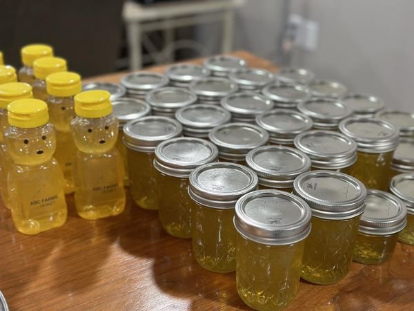 Honey jars and bears lined up on a table