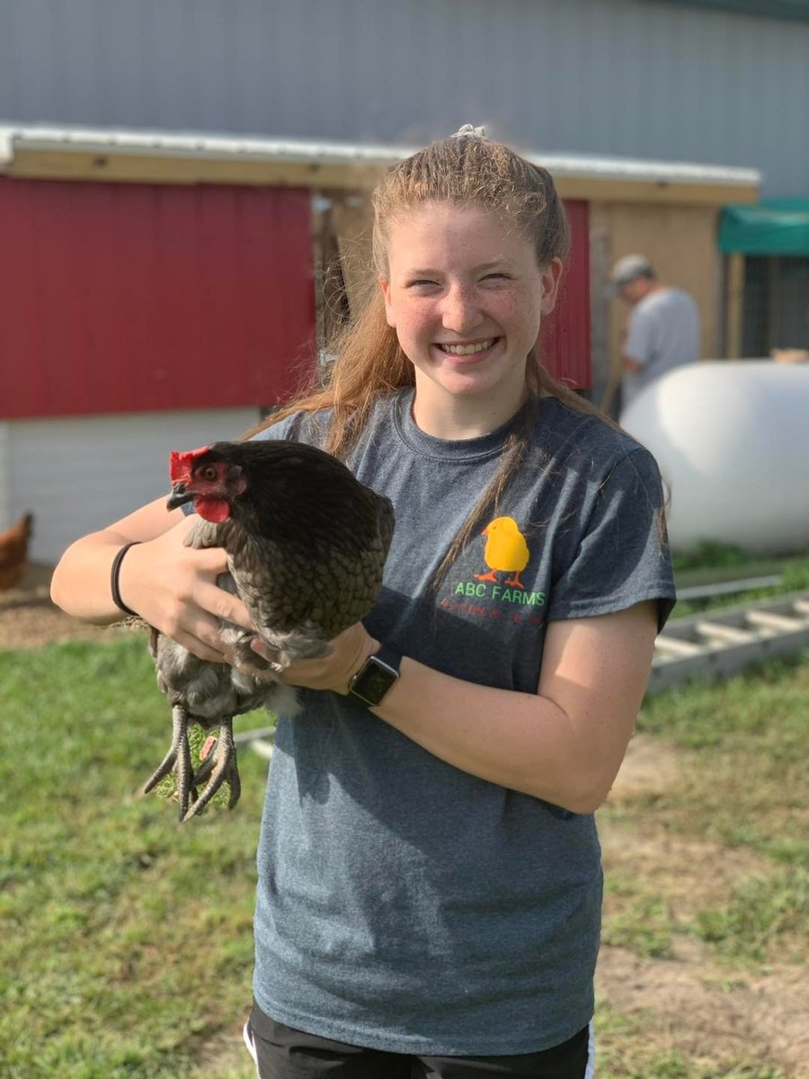One of the ABC Farms kids holding a chicken